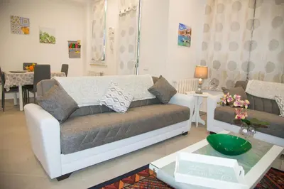 a living room with a couch and a table at MONDELLO MANICK MARE in Palermo