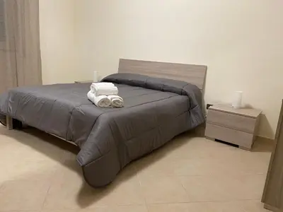 a bed with two towels on it in a bedroom at Casa Olivella in Santa Flavia