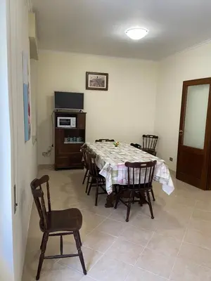 a dining room with a table and chairs at Casa Olivella in Santa Flavia