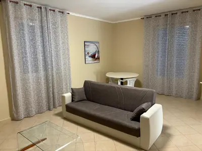 a living room with a couch and a table at Casa Olivella in Santa Flavia