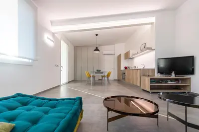 a living room with a blue couch and a table at Villa Cappèddu in Balestrate