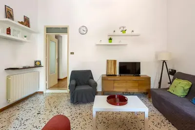a living room with a couch and a tv at mondello sea view beach apartment in Palermo