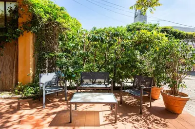 a group of chairs and a table on a patio at mondello sea view beach apartment in Palermo