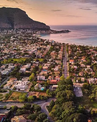 an aerial view of a city and the ocean at mondello sea view beach apartment in Palermo
