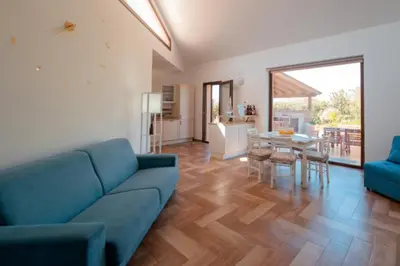 a living room with a blue couch and a table at Villa Giorgia 2020 in Cefalù