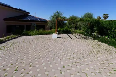a brick driveway with a pole in front of a house at Villa Giorgia 2020 in Cefalù