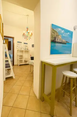 a room with a table and a painting on the wall at Briogna by Maravigghia Palermo in Palermo