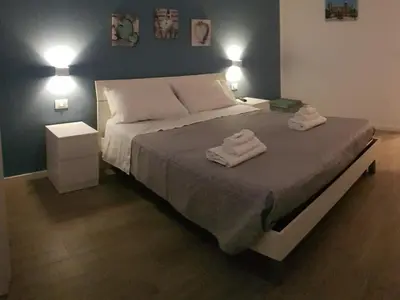 a bedroom with a bed with two towels on it at Dietro il massimo in Palermo