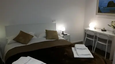 a bedroom with a bed with two towels on it at Palermo Rooms in Palermo
