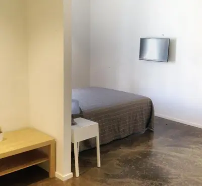 a small bedroom with a bed and a small table at Palermo Rooms in Palermo