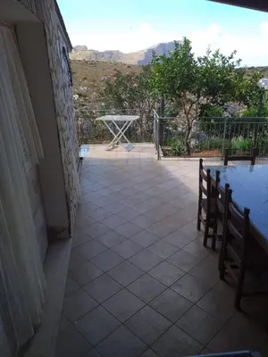 a view of a patio with a table and bench at Baglio Cracchiolo da Tuzzo - Casa Il Limone in San Vito lo Capo