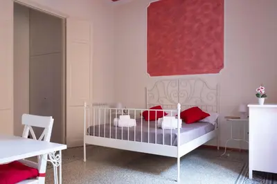 a childs bedroom with a crib and a red painting at Casa Gagliani, a Liberty house in the old downtown in Palermo