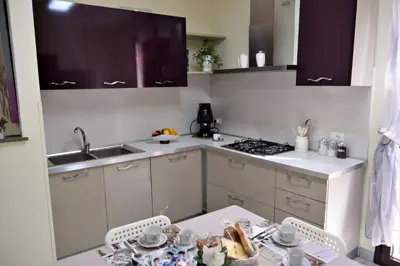a kitchen with a sink and a table with dishes on it at L'Antico Borgo di Segesta in Calatafimi