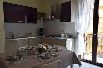 a kitchen with a table with a table cloth on it at L'Antico Borgo di Segesta in Calatafimi