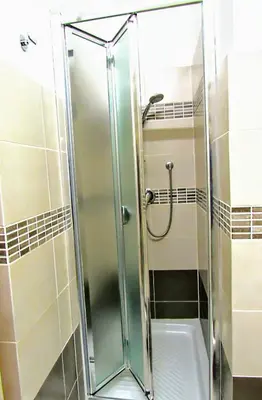 a shower with a glass door in a bathroom at L'Antico Borgo di Segesta in Calatafimi