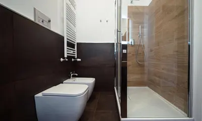 a small bathroom with a toilet and a shower at Zefiro Suites in Palermo