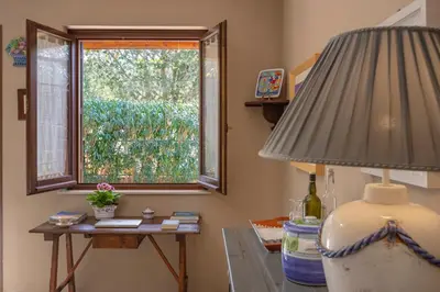 a room with a window and a table with a lamp at VILLA GIAGGIA - VICINO IL MARE in San Vito lo Capo