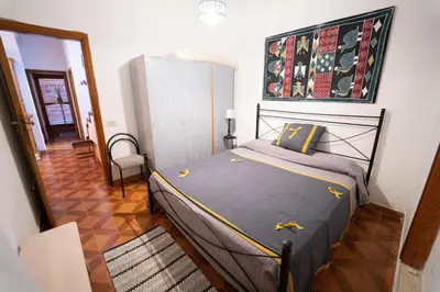 a bedroom with a bed and a chair in it at Villa Claudia in Scopello