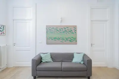 a couch in a living room with two white doors at B&B Babbaluci - Centro Storico in Palermo
