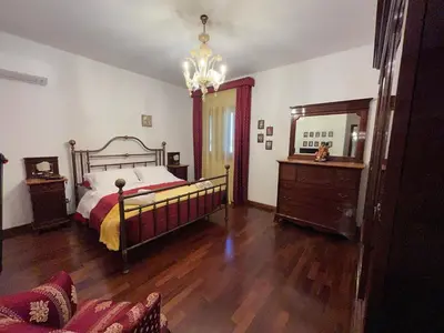 a bedroom with a bed and a dresser and a mirror at Villetta Aurora in Isola delle Femmine