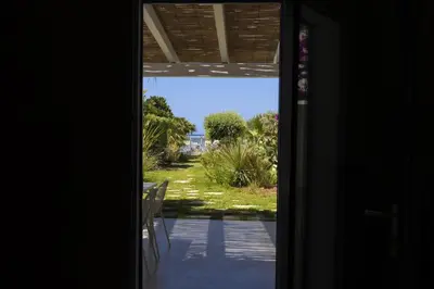 an open door with a view of a yard at Villa Turchese sul mare in San Vito lo Capo