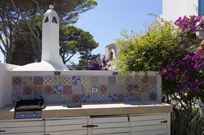 a kitchen with a mosaic counter top with a stove at Villa Turchese sul mare in San Vito lo Capo