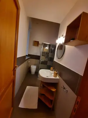 a small bathroom with a sink and a toilet at A Casa del Genio in Palermo