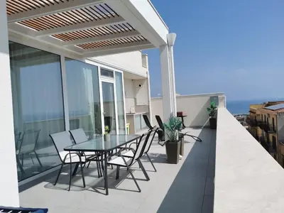 a patio with a table and chairs on a balcony at Appartamento Sul Golfo in Castellammare del Golfo