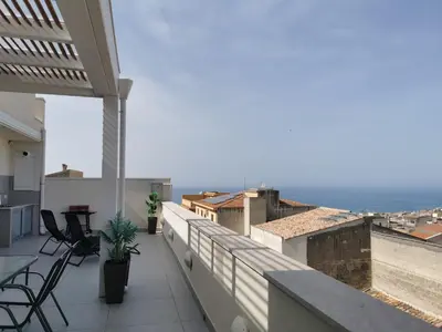 a balcony with chairs and a view of the ocean at Appartamento Sul Golfo in Castellammare del Golfo