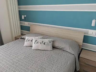 a bed with a pillow that says let love at Appartamento Sul Golfo in Castellammare del Golfo