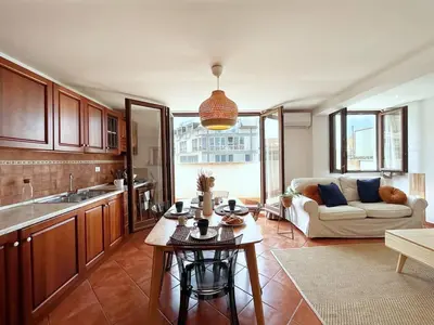 a kitchen and living room with a couch and a table at Solemar Sicilia - Palazzo Massimo in Palermo