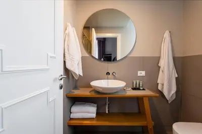 a bathroom with a sink and a mirror at Villa Masetta - Luxury Suites in Mondello