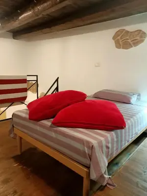 a bed with red pillows on it in a room at Mix&Match in Palermo