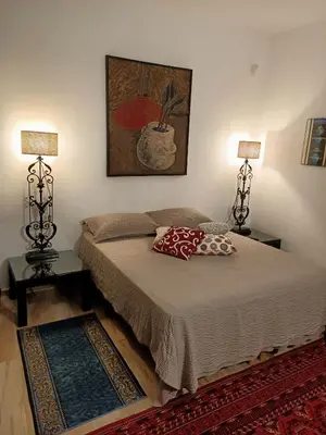 a bedroom with a bed with two lamps and a rug at Mix&Match in Palermo