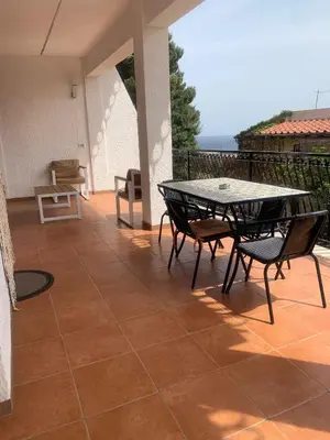 a patio with a table and chairs on a balcony at Elite Residence Mondello in Mondello