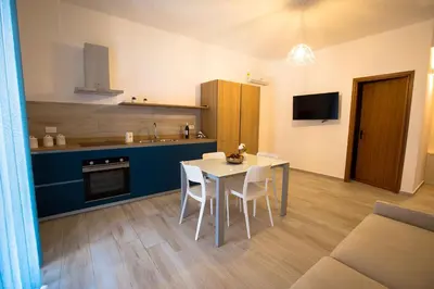 a kitchen and dining room with a table and chairs at Casa Vacanza Barone in Castellammare del Golfo