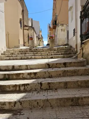 an alley with stairs in an old town at Voltamare in Castellammare del Golfo