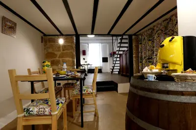 a restaurant with a bar with chairs and a table at Il Siciliano home in Palermo