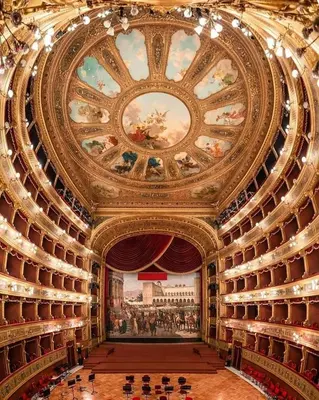 a library with a painting on the ceiling and shelves at Il Siciliano home in Palermo