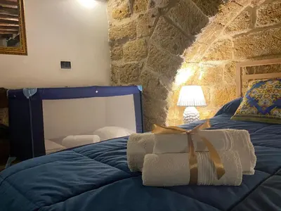 a bedroom with a bed with a gift on it at Il Siciliano home in Palermo
