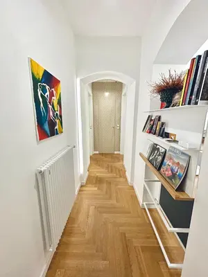 a hallway with white walls and a wooden floor at Archè Design Rooms and Suites in Palermo