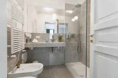a bathroom with a sink and a toilet and a shower at Archè Design Rooms and Suites in Palermo