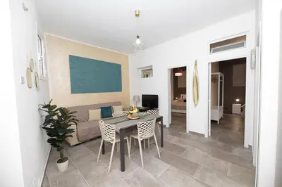 a living room with a table and a couch at Casa Raffadali, in centro storico a Palermo in Palermo