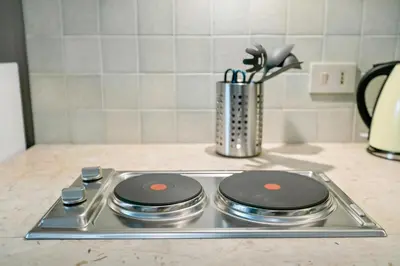 a stove top with two burners on top of it at GuestHost - Stylish Flat Maqueda in Palermo