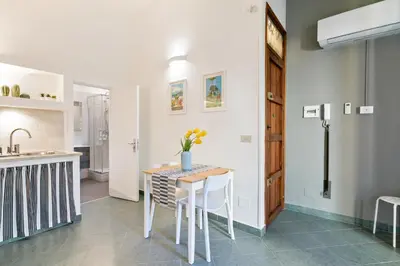 a kitchen and dining room with a table and chairs at GuestHost - Stylish Flat Maqueda in Palermo