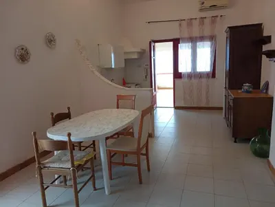a kitchen and dining room with a table and chairs at la finestra sul mare piano 2 in Trappeto