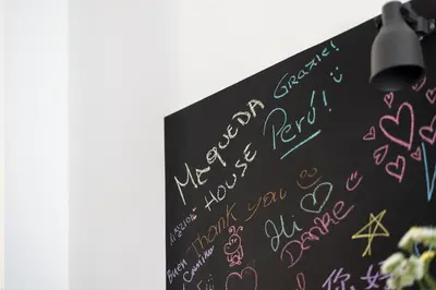a chalkboard with writing on it with a light at Maqueda House in Palermo