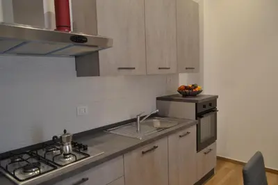 a kitchen with a sink and a stove top oven at Appartamento del Golfo in Castellammare del Golfo