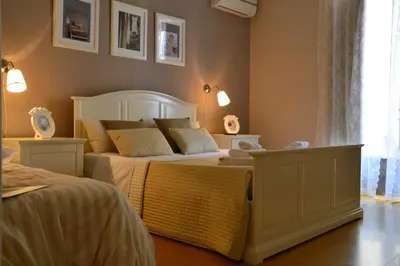 a bedroom with a large white bed and a window at B&B Abbacò in Palermo