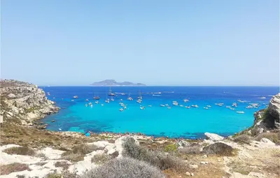 a group of boats in the water on a beach at Stunning Home In Castellammare Del G in Castellammare del Golfo